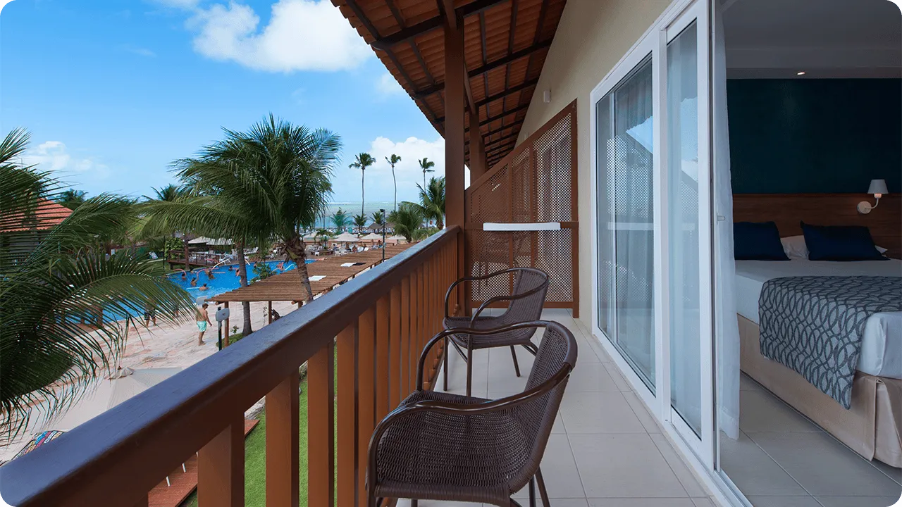 varanda do apartamento superior Varanda da acomodação superior, com duas cadeiras e vista para a piscina.