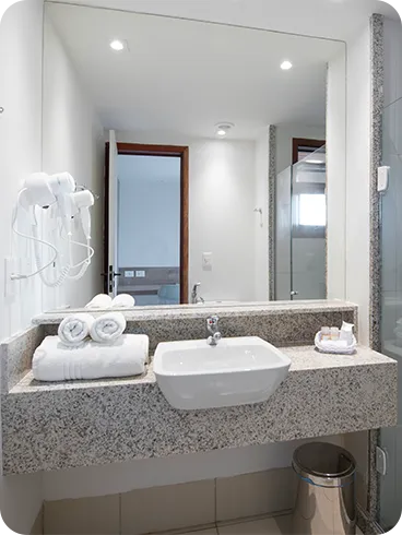 banheiro da acomodação standard Banheiro da acomodação Standard, contendo área pra banho, instalações sanitárias, chuveiro com regulação de temperatura, decoração, amenities O Boticário, toalhas, grande espelho e secador de cabelo.